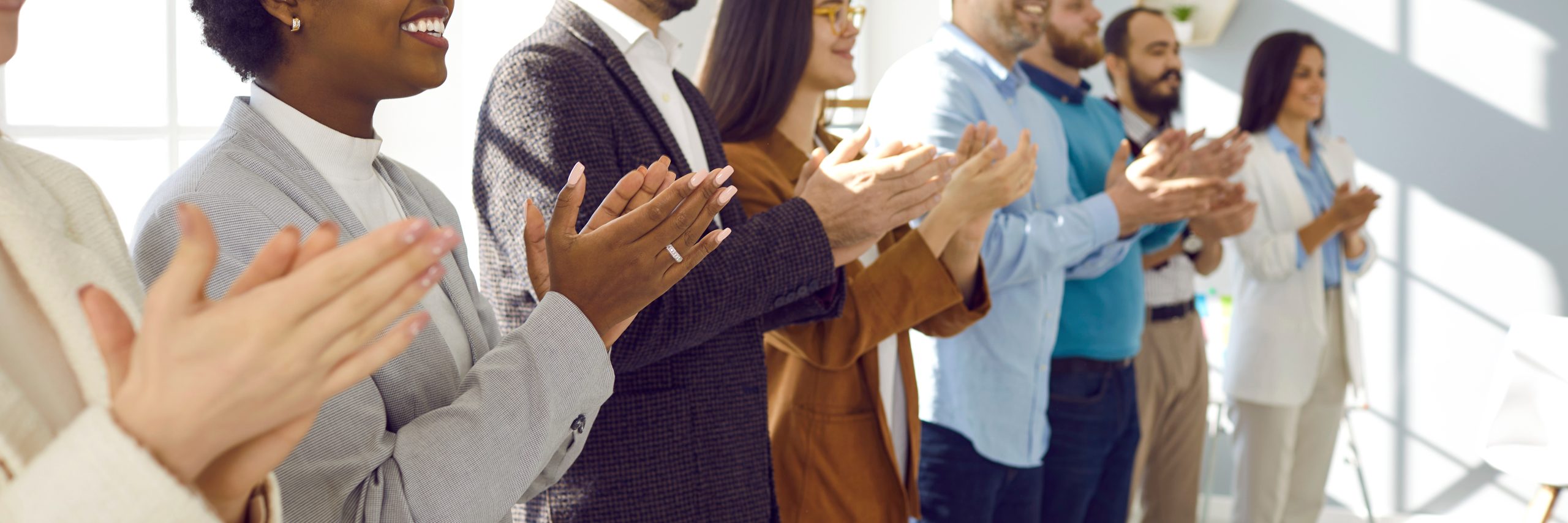Crowd-of-office-professionals-applauding-scaled